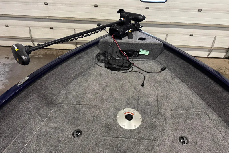 Slide: The Image of 2025 Tracker Pro Guide V-175 Combo boat interior with trolling motor and carpeted deck. - 13
