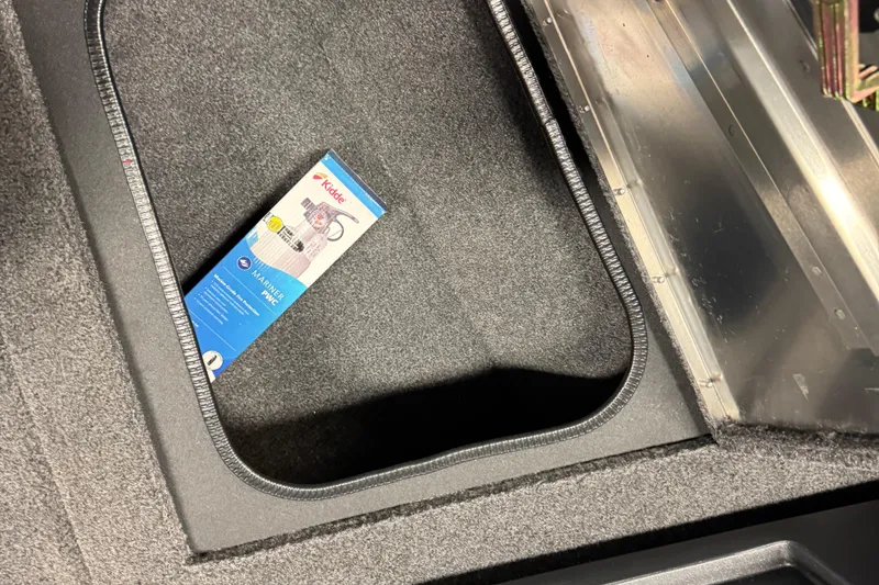 Slide: The Image of Storage compartment in 2025 Tracker Pro Guide V-175 Combo boat with a Kidde fire extinguisher. - 16