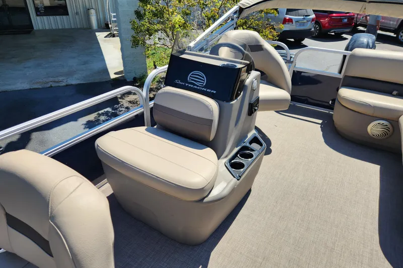 Slide: The Image of 2023 Sun Tracker Bass Buggy 16 XL Select interior with beige seating and console. - 11