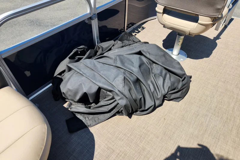 Slide: The Image of 2023 Sun Tracker Bass Buggy 16 XL Select interior with folded black cover on deck. - 12