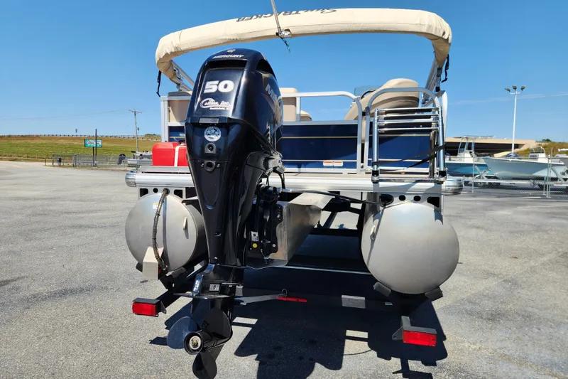 Slide: The Image of 2023 Sun Tracker Bass Buggy 16 XL Select pontoon boat with 50 HP engine, rear view. - 3