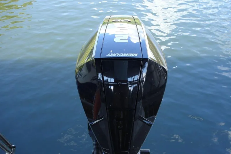 Slide: The Image of 2024 Manitou LX 25 RFX boat with Mercury engine on water. - 5