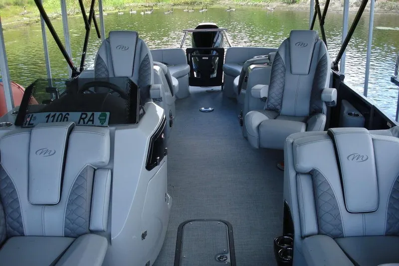 Slide: The Image of 2024 Manitou LX 25 RFX boat interior with luxurious seating and modern design. - 7