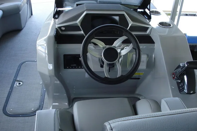 Slide: The Image of 2024 Manitou LX 25 RFX boat helm with modern steering and controls. - 8