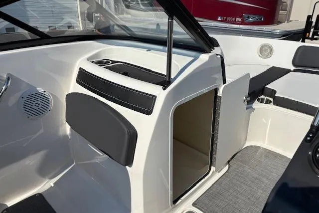 Slide: The Image of 2021 Bayliner VR5 Bowrider I/O interior with open storage compartment and seating area. - 10