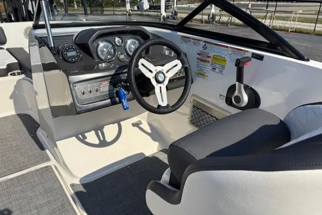 Slide: The Image of 2021 Bayliner VR5 Bowrider I/O cockpit with steering wheel and dashboard controls. - 7