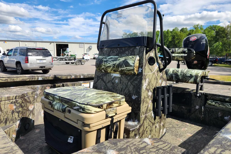 Slide: The Image of 2024 Ranger RB200 boat with camouflage design, featuring seating and storage, parked outdoors. - 10