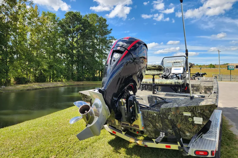 Slide: The Image of 2024 Ranger RB200 boat with powerful outboard motor, parked near a serene lake. - 3