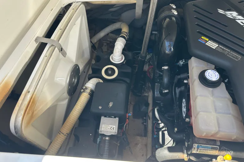Slide: The Image of Engine compartment of a 2005 Formula 260 Bowrider boat, showcasing mechanical components. - 17