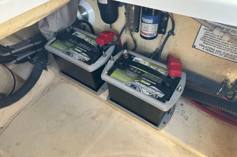 Slide: The Image of Two marine batteries in a 2005 Formula 260 Bowrider boat compartment. - 18
