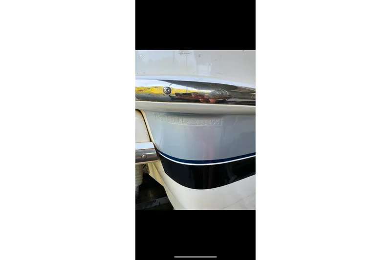 Slide: The Image of 2005 Formula 260 Bowrider boat hull detail with chrome and blue accents. - 22