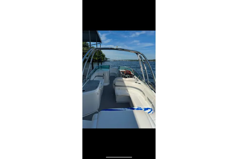 Slide: The Image of 2005 Formula 260 Bowrider boat on trailer, parked outdoors under clear sky. - 3