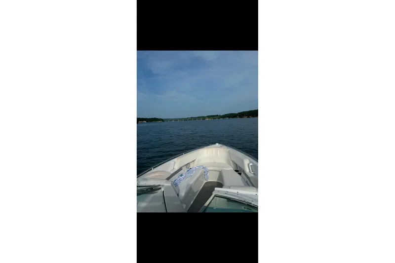 Slide: The Image of 2005 Formula 260 Bowrider boat on trailer, parked outdoors near trees. - 5