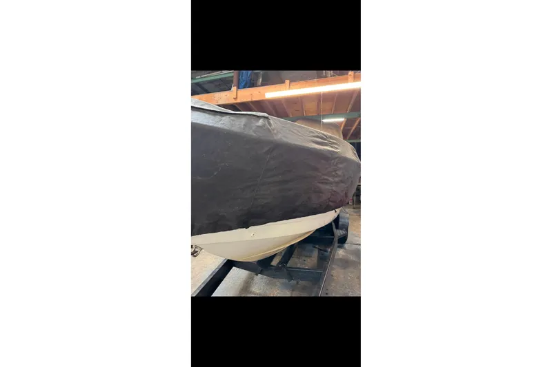 Slide: The Image of 2005 Formula 260 Bowrider boat interior with white seating and cup holders. - 8