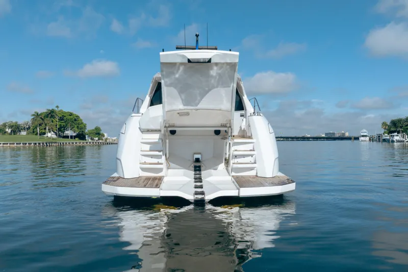 Slide: The Image of 2019 Filippetti S55 yacht on calm water, rear view with open deck. - 30