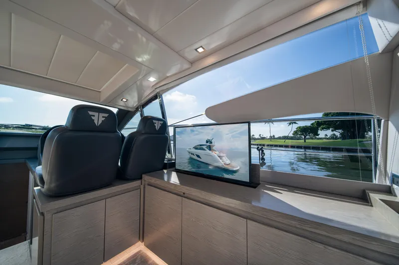 Slide: The Image of Interior of 2019 Filippetti S55 yacht with luxury seating and scenic window view. - 8