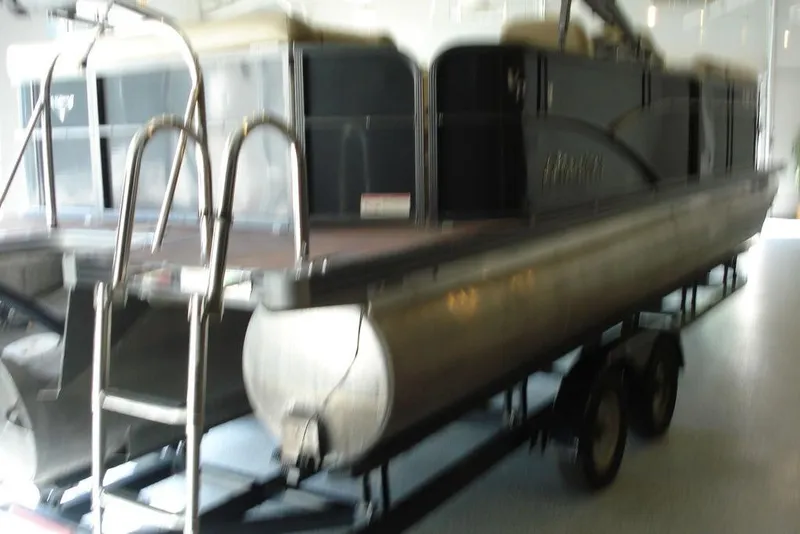 Slide: The Image of Blurry image of a 2016 Manitou 23 VP Aurora pontoon boat on a trailer. - 6