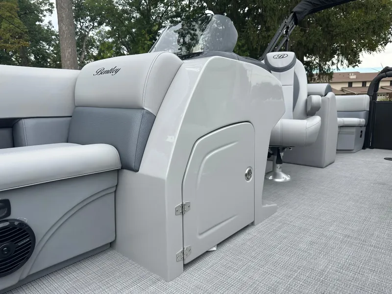Slide: The Image of 2025 Bentley Pontoons Legacy 220 Navigator interior with sleek seating and modern design. - 11