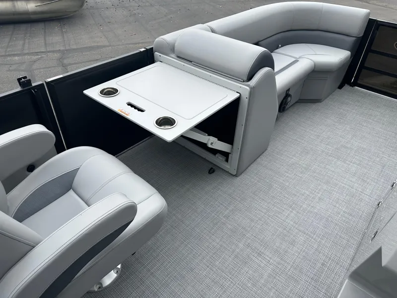 Slide: The Image of 2025 Bentley Pontoons Legacy 220 Navigator interior with gray seating and foldable table. - 17