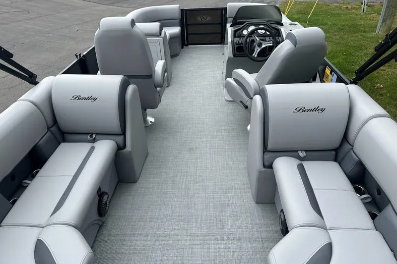 Slide: The Image of 2025 Bentley Pontoons Legacy 220 Navigator interior with luxurious gray seating and modern design. - 18