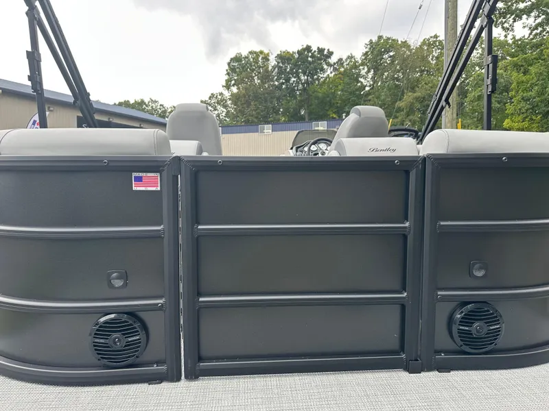 Slide: The Image of 2025 Bentley Pontoons Legacy 220 Navigator, rear view with speakers and American flag decal. - 6