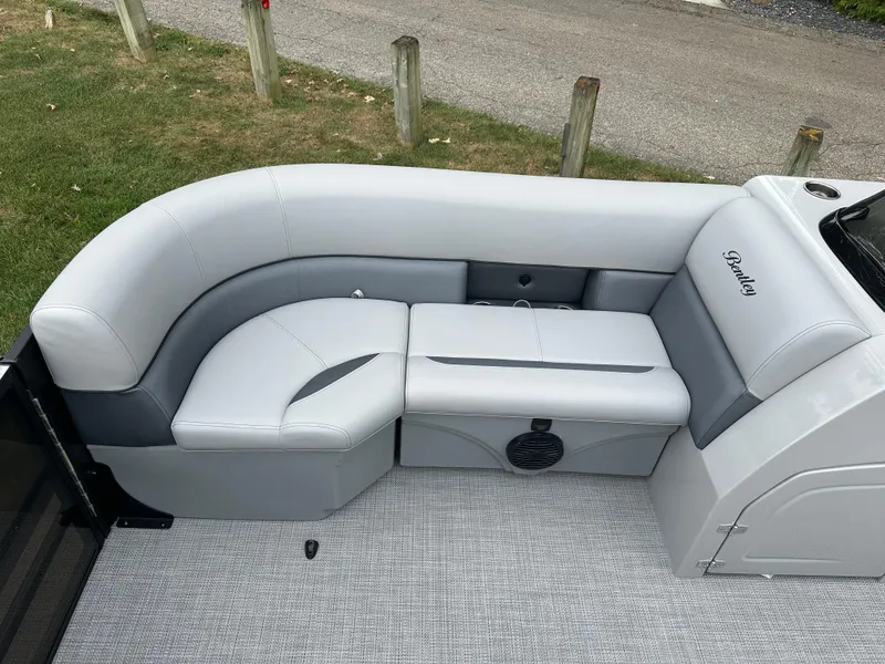 Slide: The Image of 2025 Bentley Pontoons Legacy 220 Navigator interior with gray seating and speaker. - 8