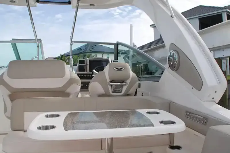 Slide: The Image of 2017 Chaparral 310 Signature boat interior with seating and table, showcasing luxury design. - 13
