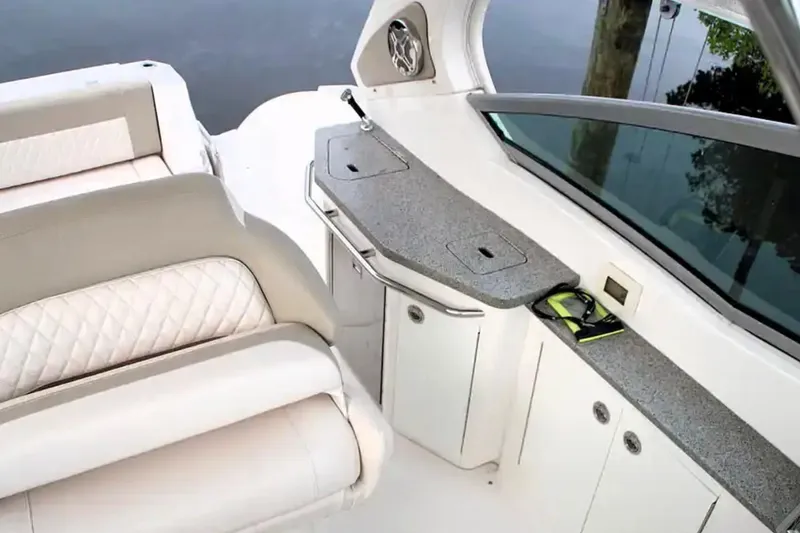 Slide: The Image of 2017 Chaparral 310 Signature boat interior with luxurious seating and sleek countertops. - 15