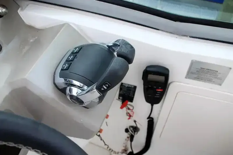 Slide: The Image of Control panel of 2017 Chaparral 310 Signature boat with throttle and communication device. - 21