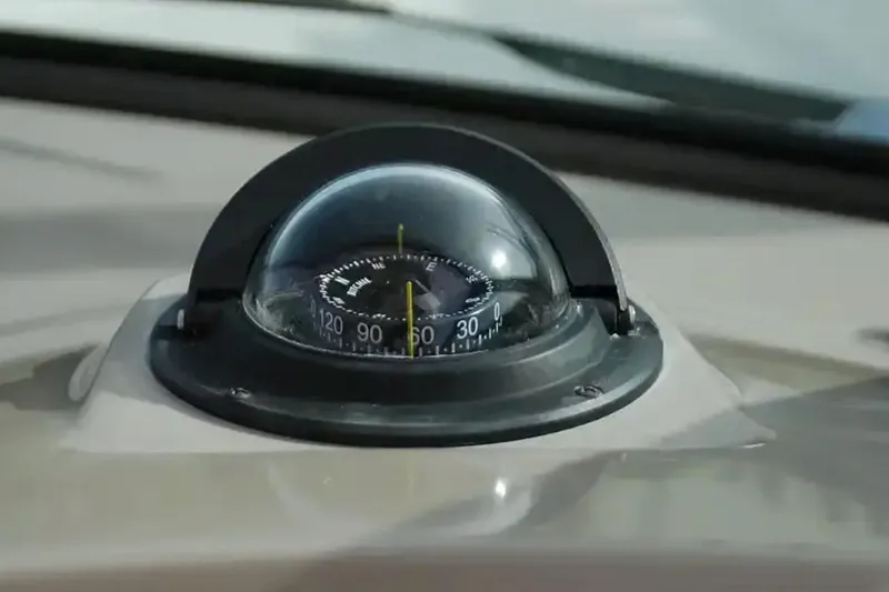 Slide: The Image of Compass on 2017 Chaparral 310 Signature boat dashboard, close-up view. - 24