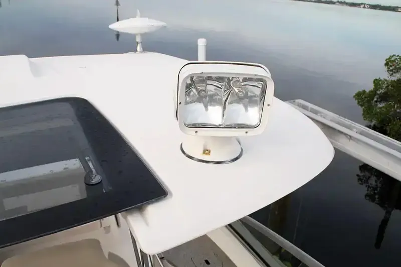 Slide: The Image of 2017 Chaparral 310 Signature boat spotlight and deck detail by the water. - 32