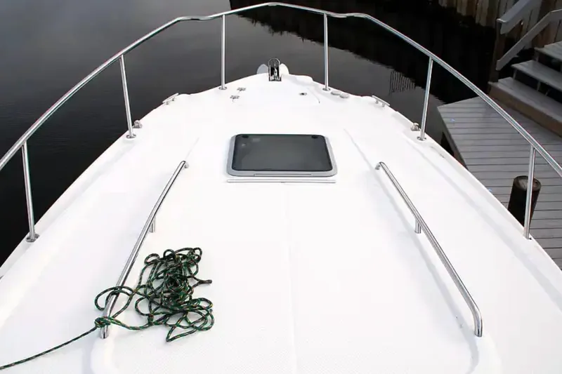 Slide: The Image of 2017 Chaparral 310 Signature boat deck with railing and coiled rope. - 34