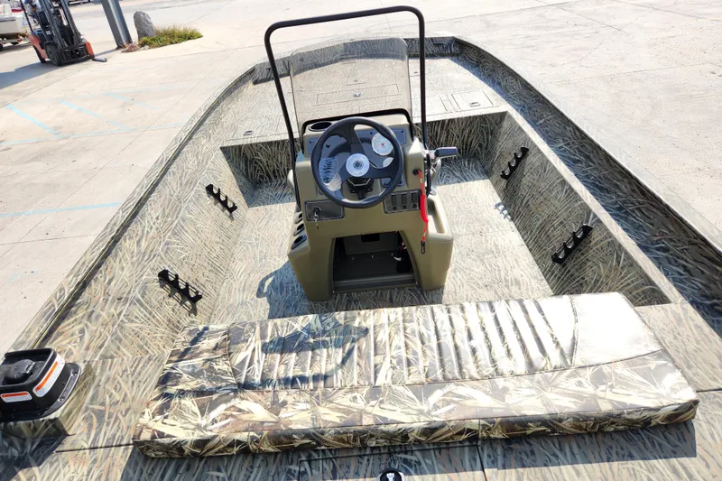 Slide: The Image of 2025 Tracker Grizzly 2072 CC boat with camo interior and central console. - 10