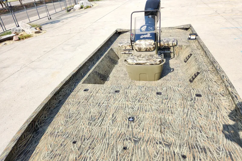 Slide: The Image of 2025 Tracker Grizzly 2072 CC boat with camouflage design, featuring spacious deck and seating. - 13