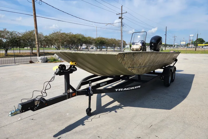 Slide: The Image of 2025 Tracker Grizzly 2072 CC boat on trailer, parked outdoors under clear sky. - 4