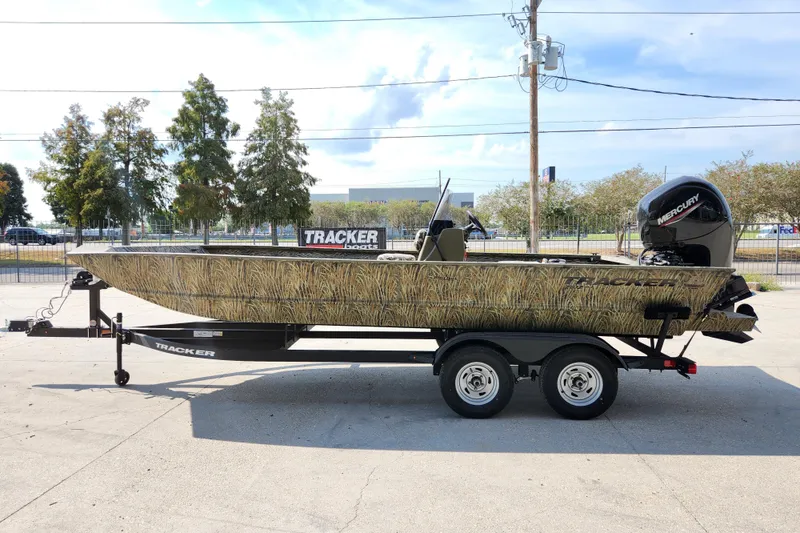 Slide: The Image of 2025 Tracker Grizzly 2072 CC boat with camouflage design on a trailer. - 5