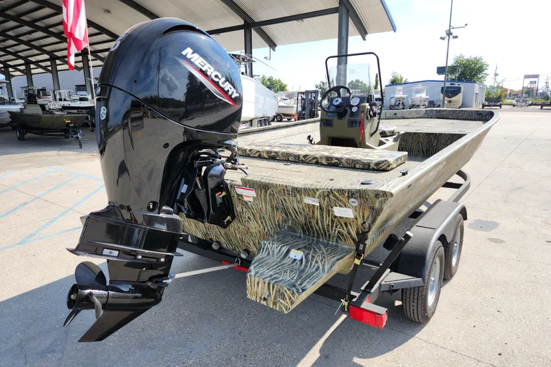 Slide: The Image of 2025 Tracker Grizzly 2072 CC boat with Mercury engine, parked outdoors. - 8