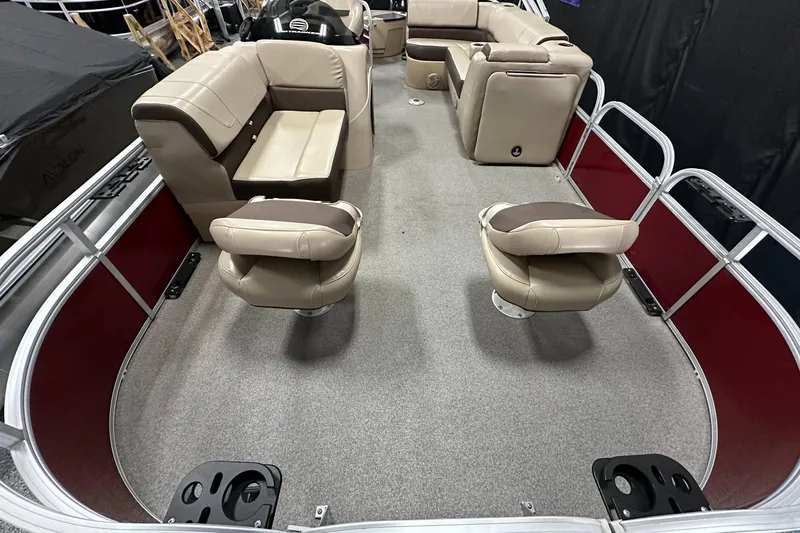 Slide: The Image of 2018 Sun Tracker SFB20 pontoon boat interior with beige seating and gray flooring. - 11