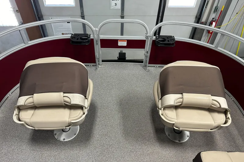 Slide: The Image of 2018 Sun Tracker SFB20 boat interior with two beige seats and red railing. - 13