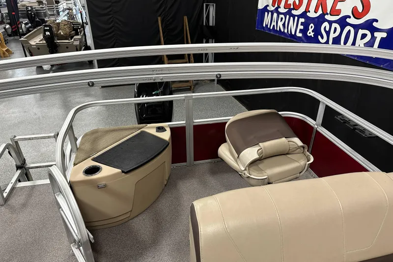 Slide: The Image of 2018 Sun Tracker SFB20 pontoon boat interior with seating and console. - 18