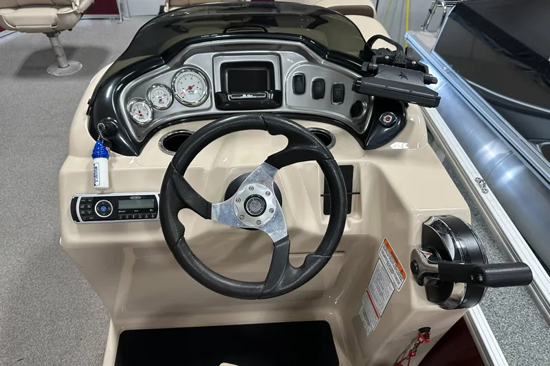 Slide: The Image of 2018 Sun Tracker SFB20 boat dashboard with steering wheel and control panel. - 22