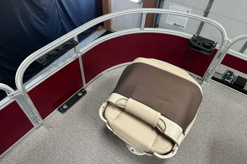 Slide: The Image of 2018 Sun Tracker SFB20 boat interior with beige seat and red railing. - 23
