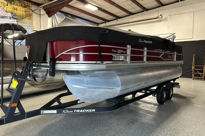Slide: The Image of 2018 Sun Tracker SFB20 pontoon boat on trailer in indoor storage facility. - 3