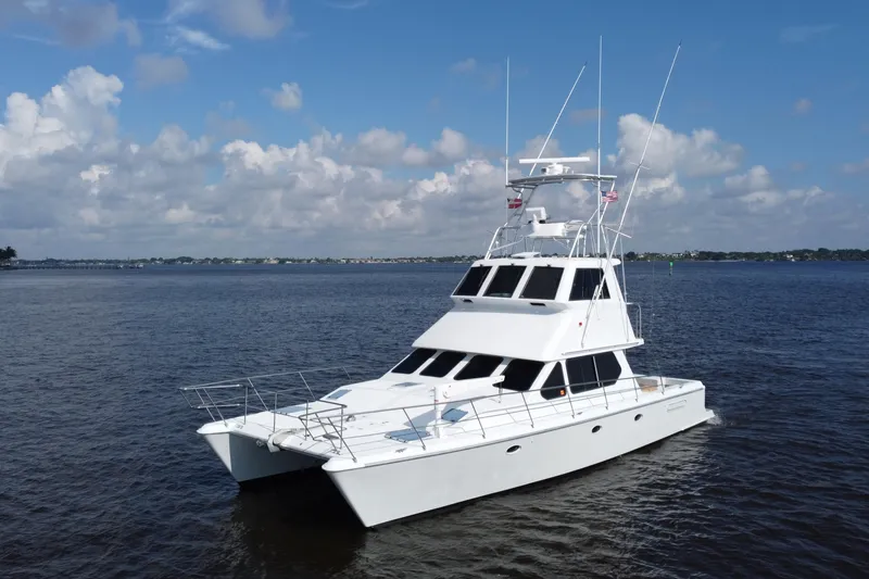 Slide: The Image of Voyager 44 yacht from 2000 on calm waters under a partly cloudy sky. - 0
