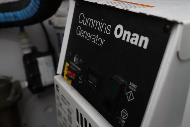 Slide: The Image of Cummins Onan generator in a 2000 Venturer 44 boat engine room. - 105