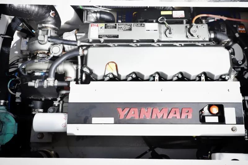 Slide: The Image of Yanmar engine in a 2000 Venturer 44 boat, showcasing mechanical components and branding. - 107