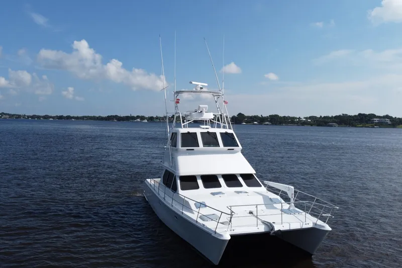 Slide: The Image of Voyager 44 yacht from 2000 on calm waters under a clear blue sky. - 11