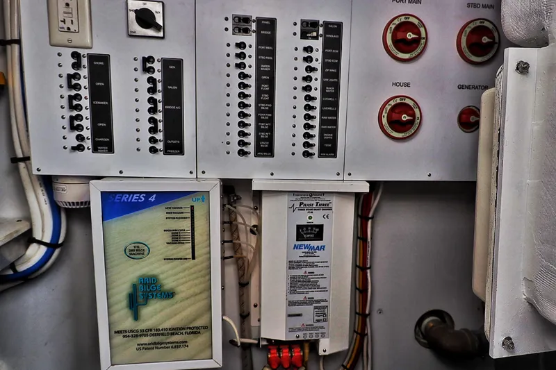 Slide: The Image of Electrical control panel on a 2000 Venturer 44 boat, featuring switches and wiring. - 111