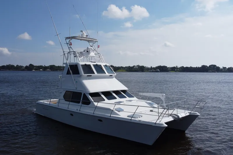 Slide: The Image of Voyager 44 yacht from 2000 on calm waters under a clear sky. - 14