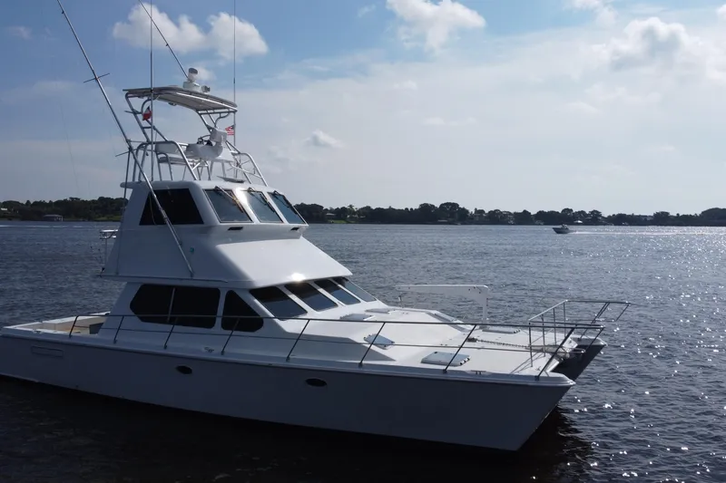 Slide: The Image of Voyager 44 yacht from 2000 on a calm lake under a partly cloudy sky. - 16